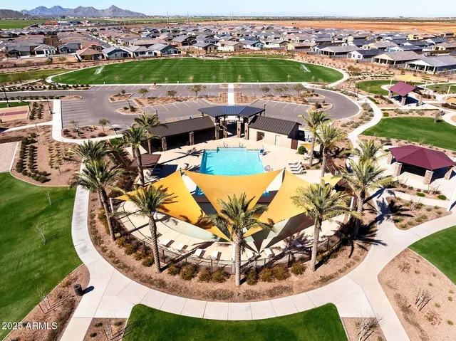 an aerial view of a house with a swimming pool yard and outdoor seating