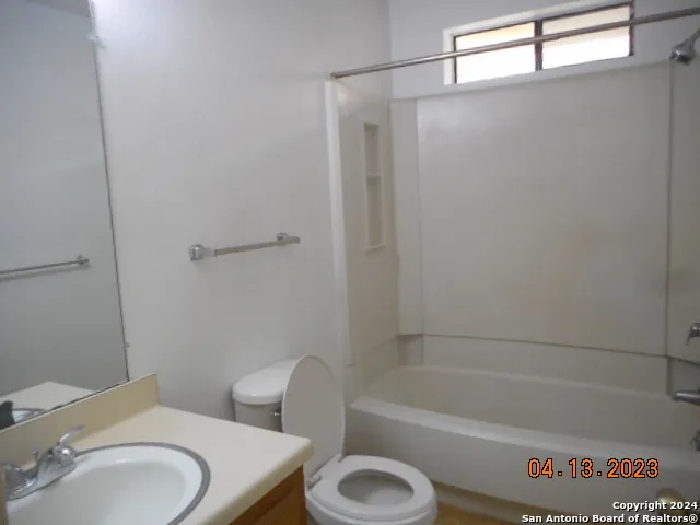 a bathroom with a toilet and a bathtub