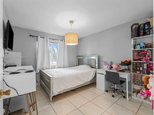 a bedroom with a bed and a chair in it