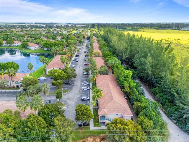 an aerial view of residential houses with outdoor space and river