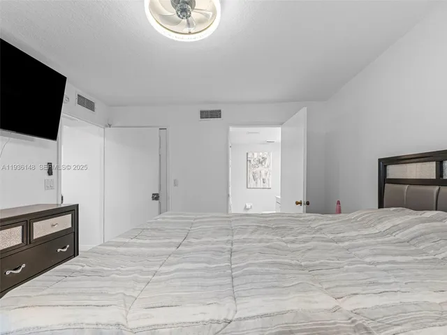 a large white bed in a white room