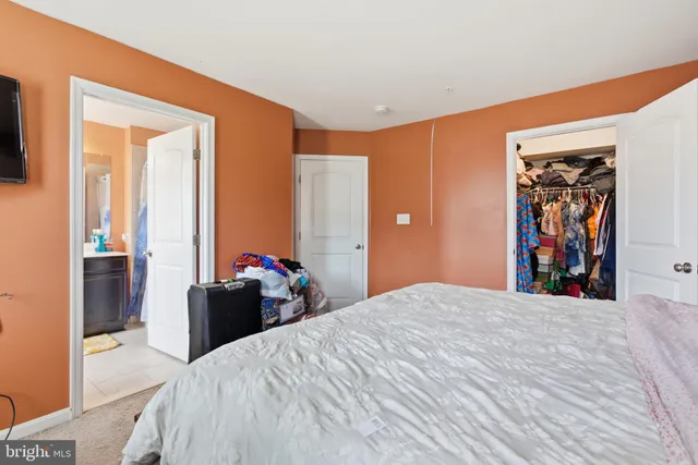 a bed room with a bed and a large mirror