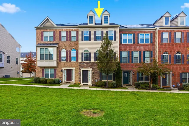a front view of a residential apartment building with a yard