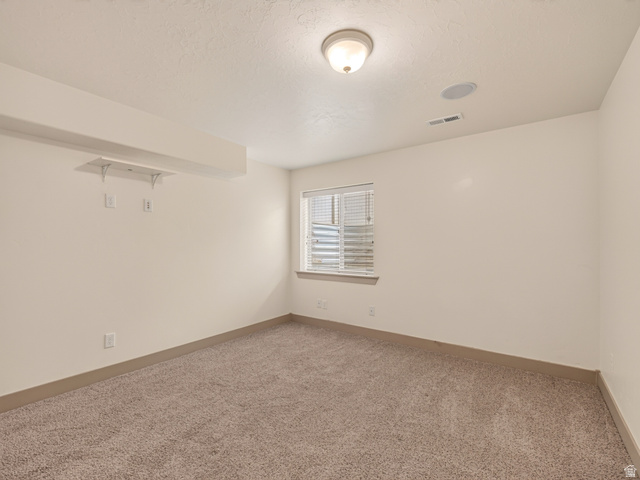 1279 West 1500th Street North Mapleton, UT 84664 - Photo 52 of 83 Carpeted room featuring a window with blinds, ceiling-mounted light fixture, and a built-in ceiling speaker