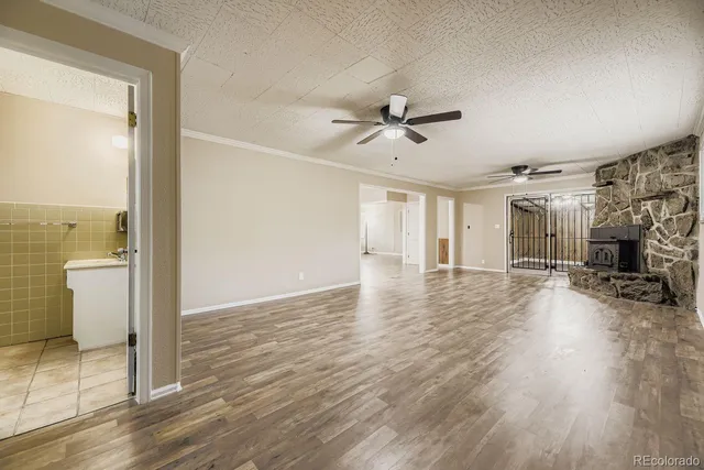 a view of a livingroom with wooden floor and a ceiling fan