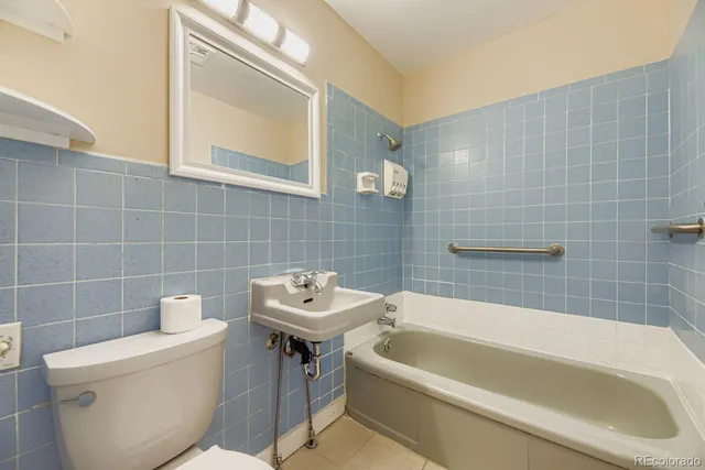 a bathroom with a sink a toilet and bathtub