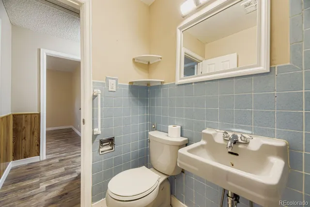 a bathroom with a sink a toilet and a mirror