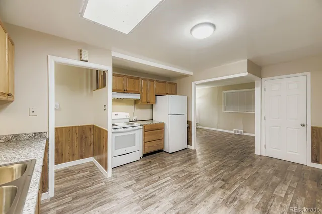 a kitchen with a stove and a refrigerator