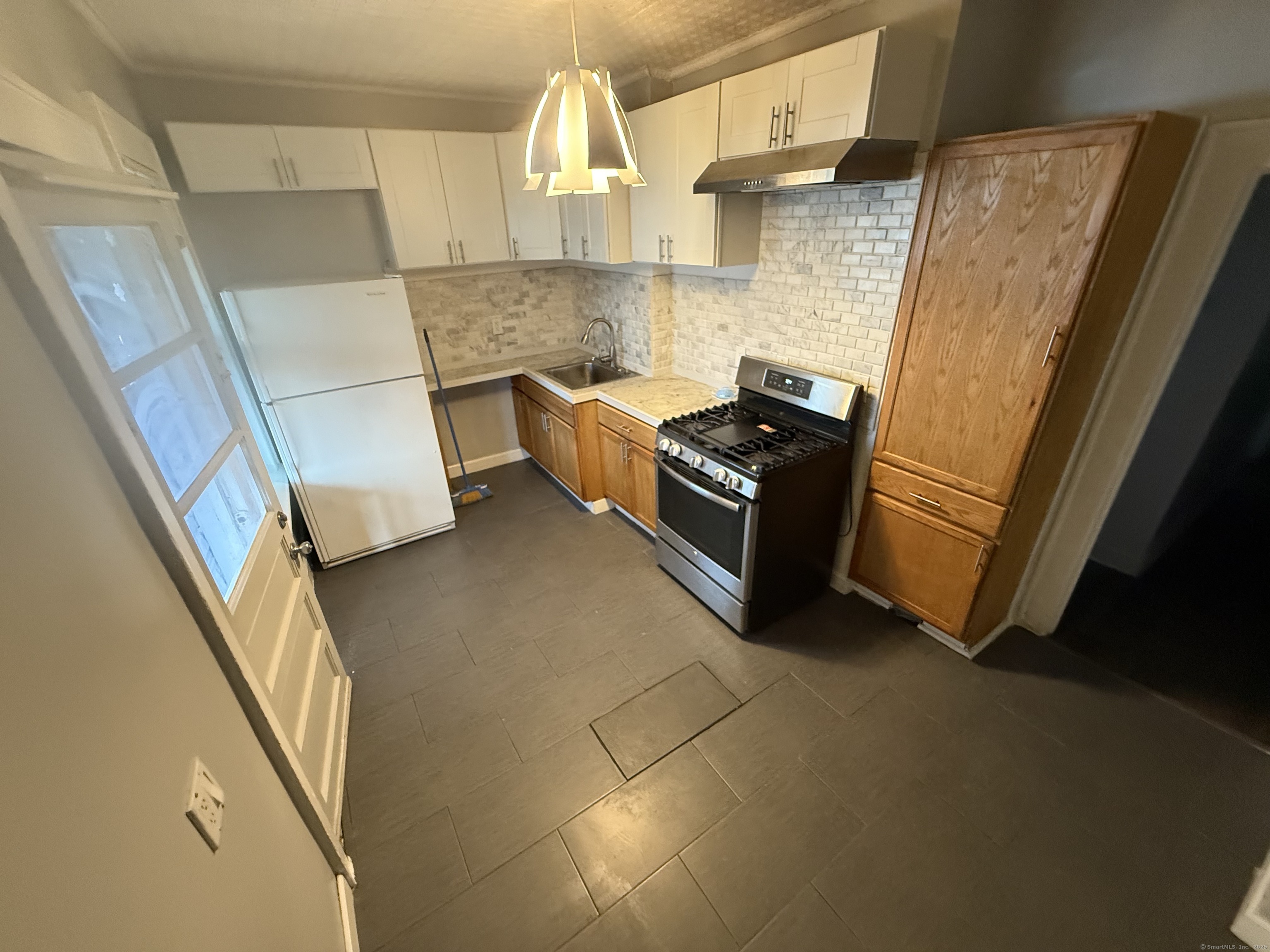 824 Capitol Avenue, Unit 2 Bridgeport, CT 06606 - Photo 3 of 9 a view of kitchen and wooden floor