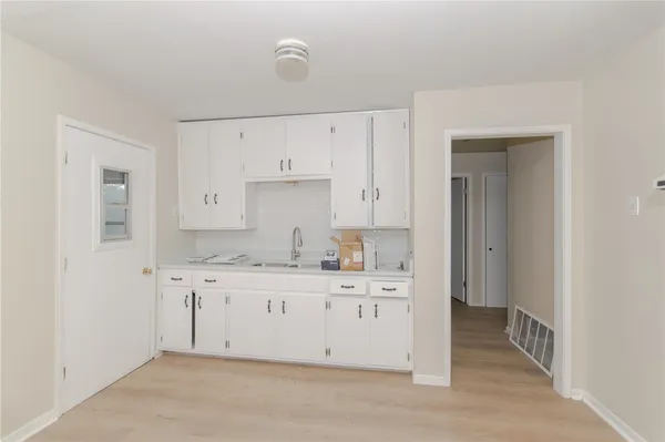 a kitchen with white cabinets