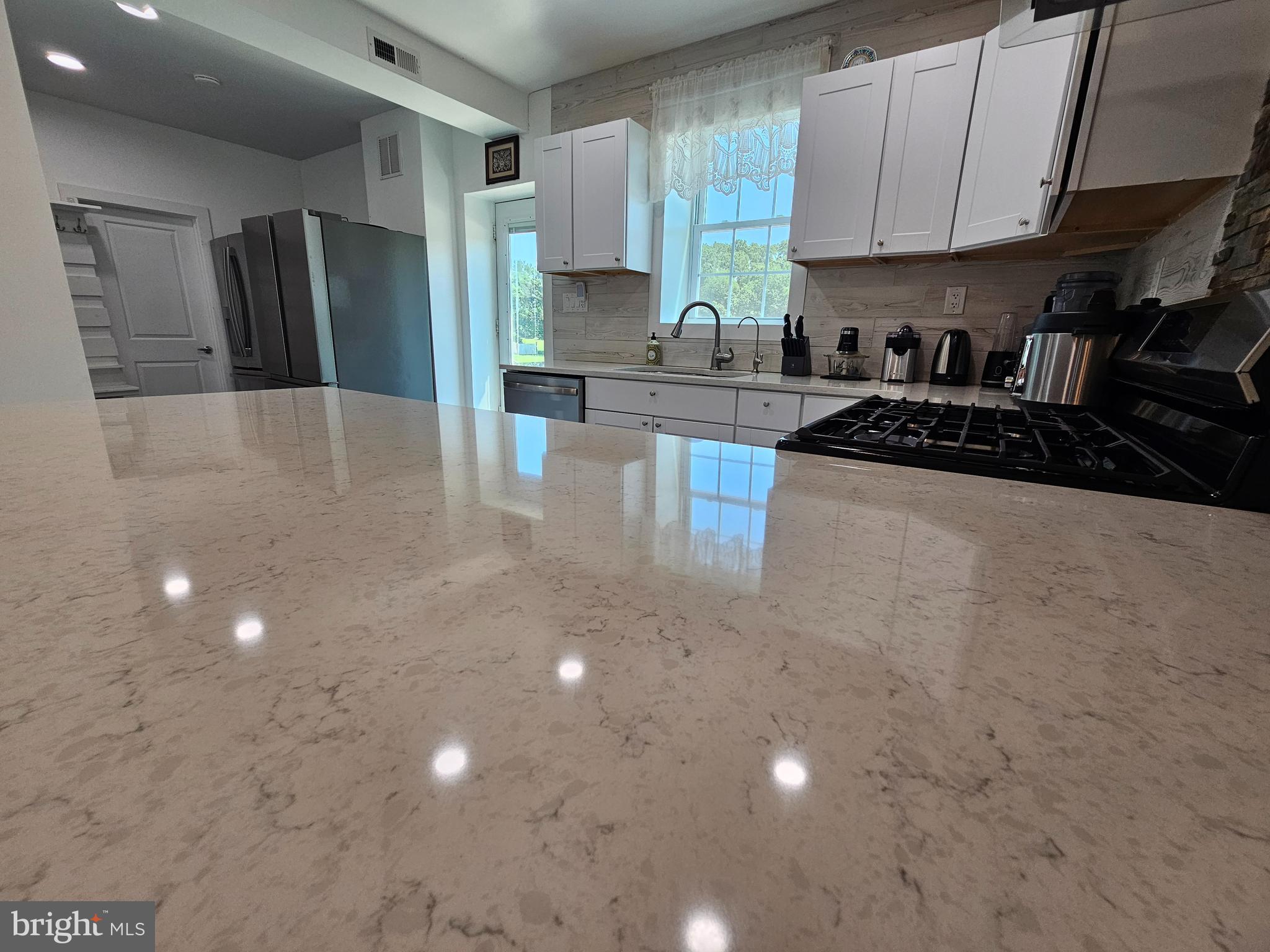 836 New Brooklyn Road Williamstown, NJ 08094 - Photo 18 of 78 a kitchen with stainless steel appliances a refrigerator sink and stove