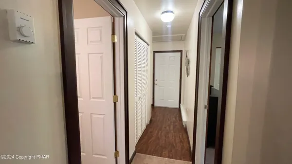 a view of a hallway with a wooden door