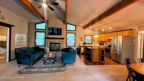a living room with furniture a flat screen tv and a fireplace