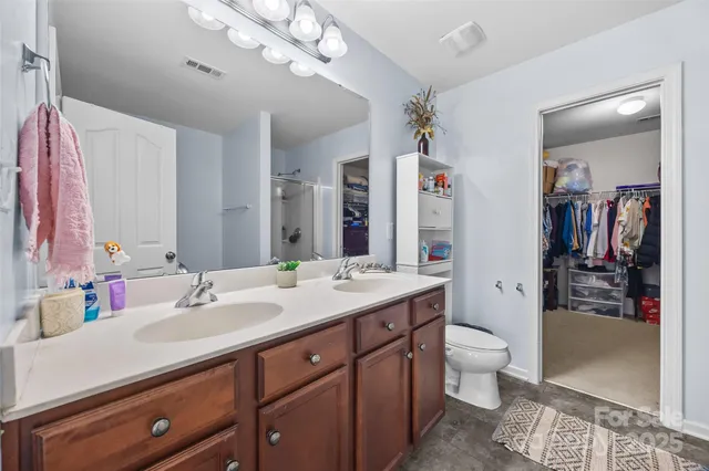 a white bath tub sitting next to a white sink and vanity
