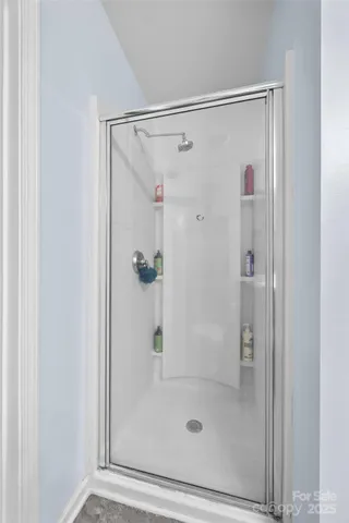 a view of walk in closet with clothes