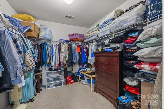 a bedroom with a bed flat screen tv and a window