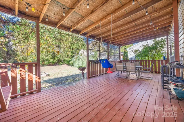 a view of balcony with wooden floor and outdoor seating