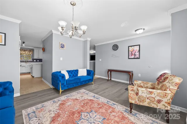 a living room with furniture wooden floor and a window