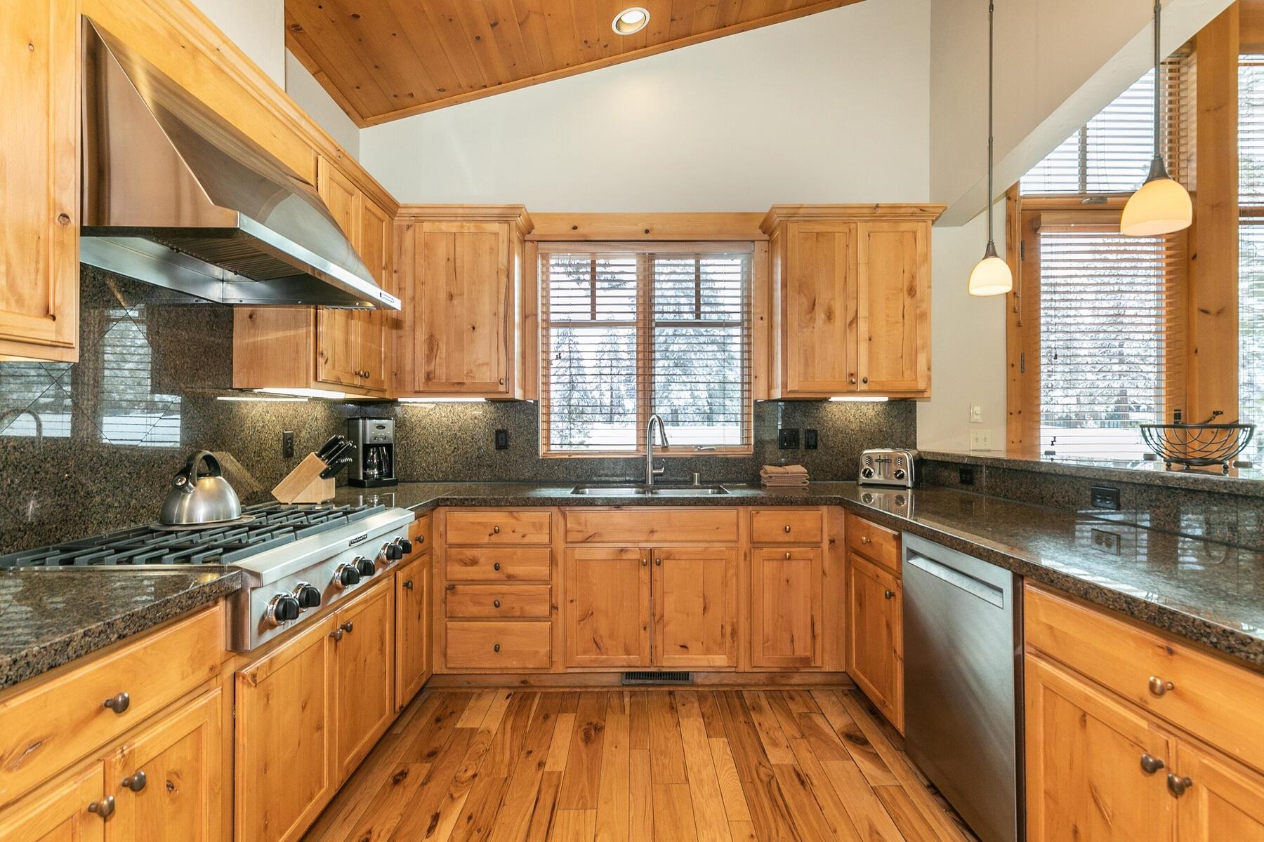 12267 Lookout Loop, Unit F713 Truckee, CA 96161 - Photo 13 of 26 a kitchen with stainless steel appliances granite countertop a sink a stove and a wooden floors