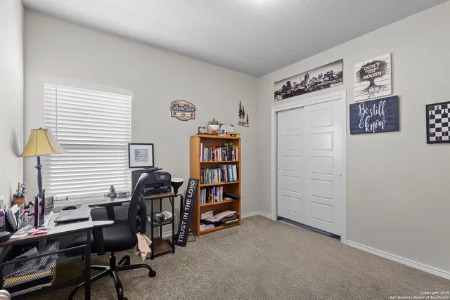 a view of a livingroom with workspace and a window
