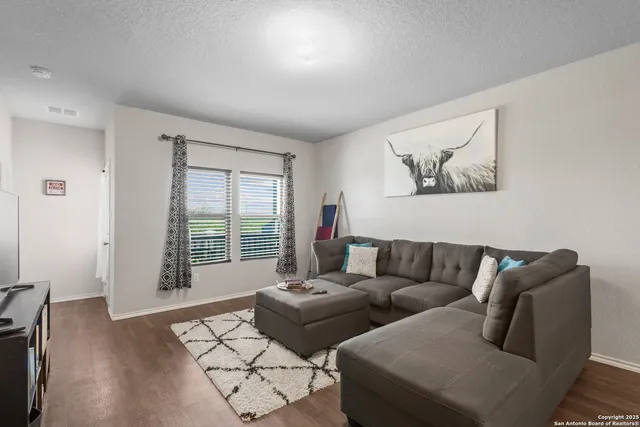 a living room with furniture and a window with outer view