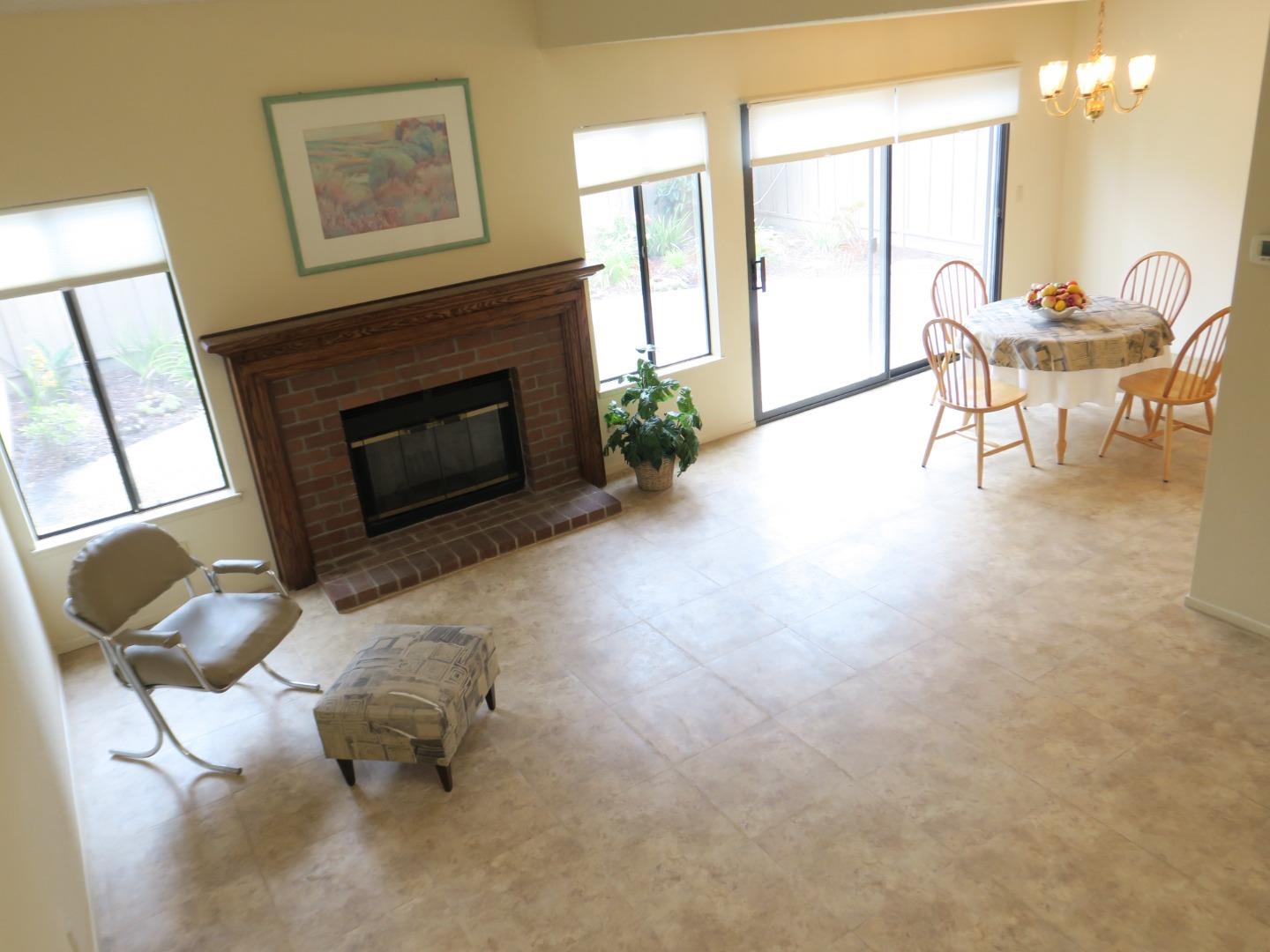 291 Klamath Road Milpitas, CA 95035 - Photo 2 of 20 a living room with furniture a large window and a fireplace
