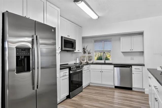 a kitchen with a refrigerator stove and sink