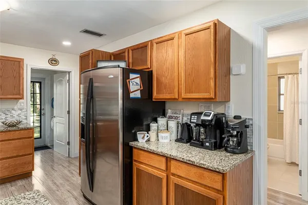 a kitchen with stainless steel appliances granite countertop a refrigerator and a sink