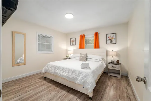 a bedroom with a bed and wooden floor