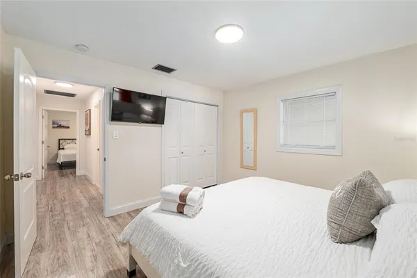 a bedroom with a bed and a flat screen tv