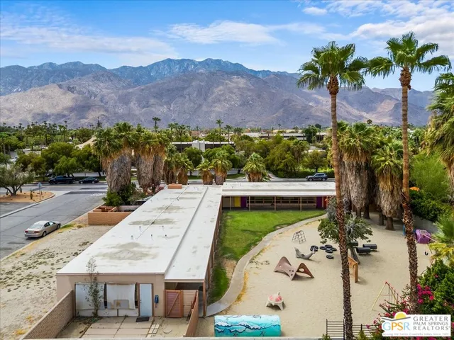 an aerial view of a house a garden and mountain view