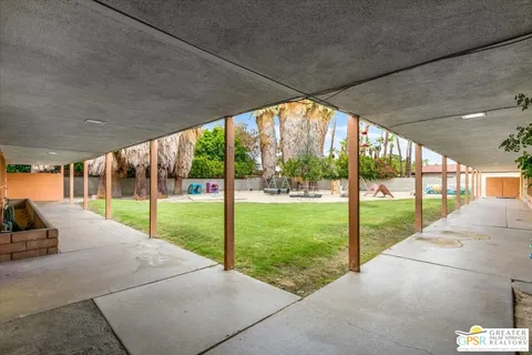 a view of backyard with floor to ceiling windows