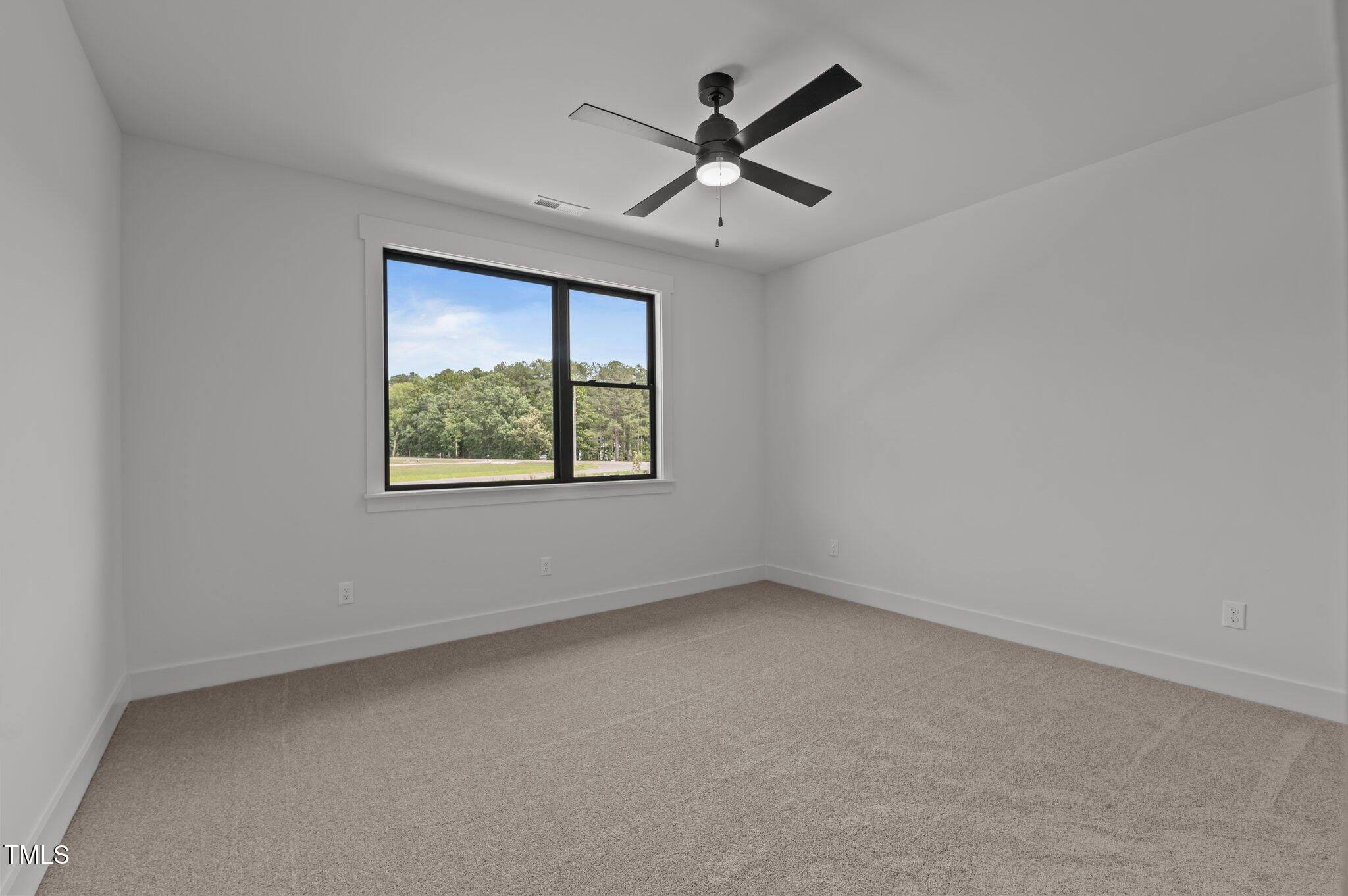 200 Broadleaf Lane Louisburg, NC 27549 - Photo 33 of 57 an empty room with a window and a fan