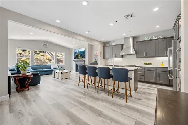 a kitchen with a table chairs microwave and cabinets