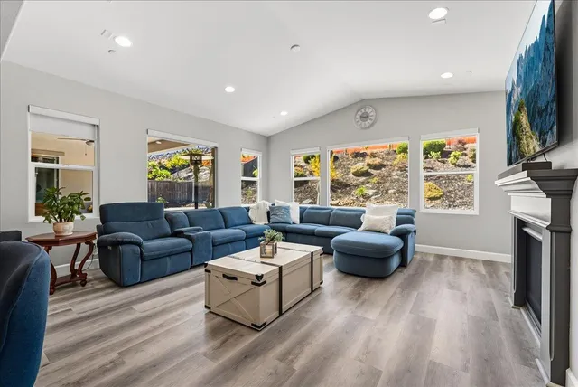 a living room with fireplace furniture and a flat screen tv