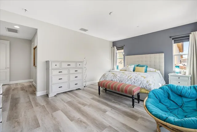 a bedroom with a bed and a large window