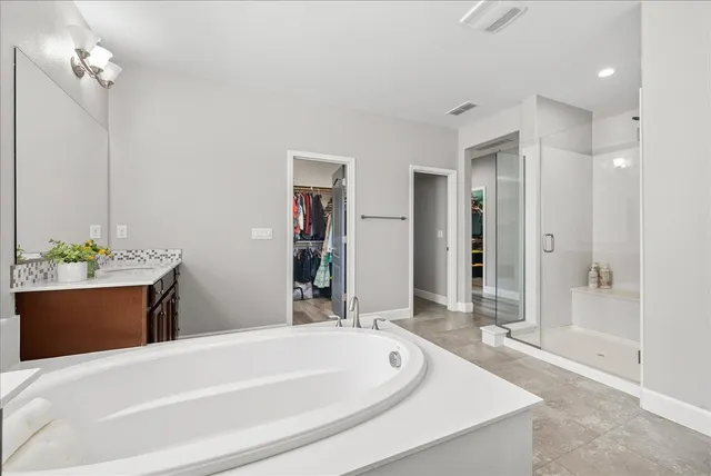 a bedroom with a bed window and a chair