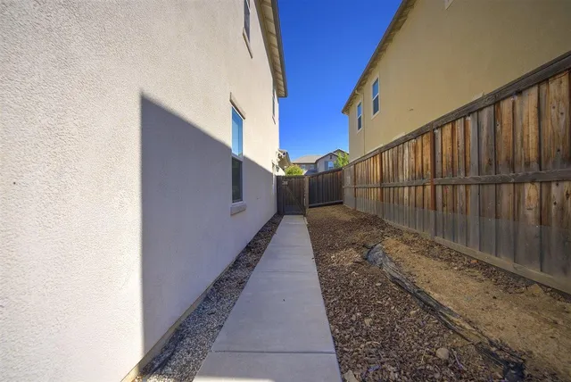 an aerial view of a house with swimming pool a yard and lake view
