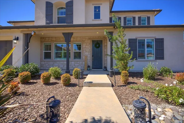 a view of a brick building with potted plants