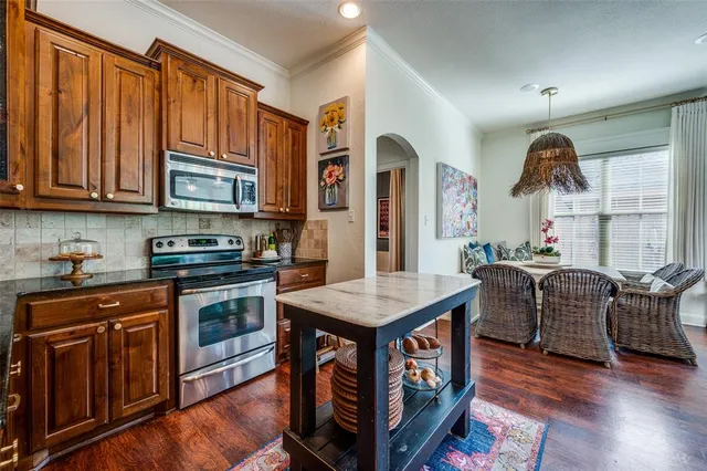 a view of a backyard with large trees and wooden fence