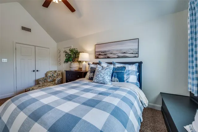 a bedroom with a bed and a potted plant