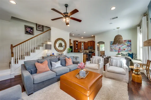 a living room with furniture a rug and a window