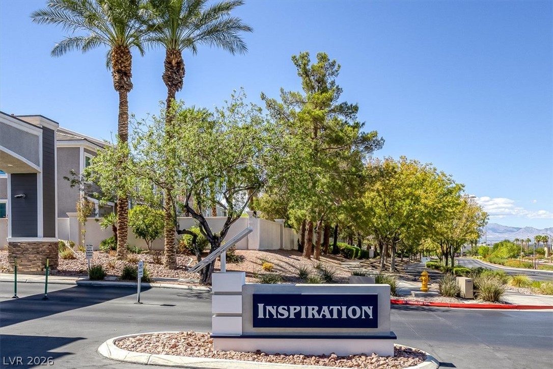 251 Integrity Ridge Drive Henderson, NV 89052 - Photo 29 of 32 Lush landscaping and established trees surround the welcoming entry to this quiet community.