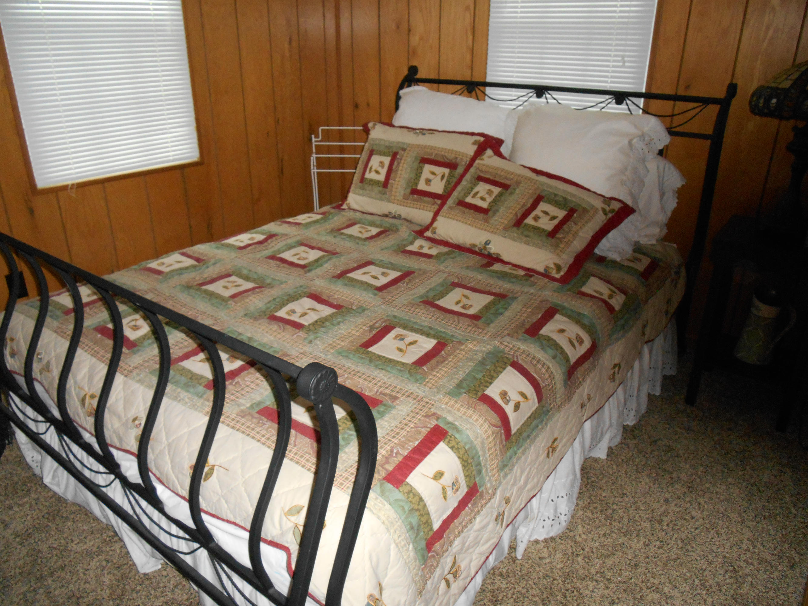 384 Lakeside Road Penhook, VA 24137 - Photo 7 of 24 a bed sitting in a bedroom next to a window