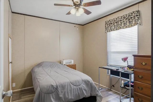 a bedroom with a bed and a desk in it