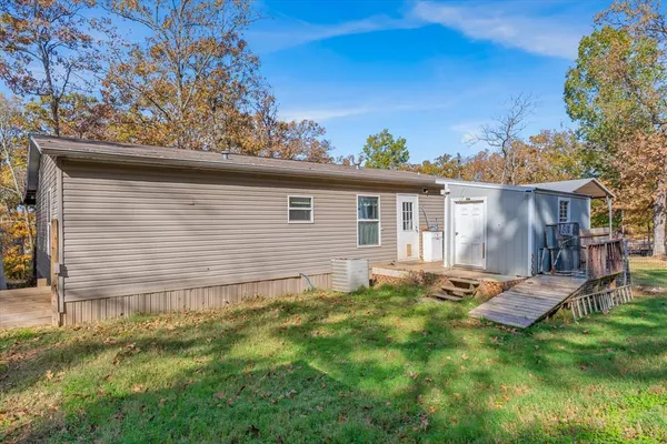 a backyard of a house with table and chairs
