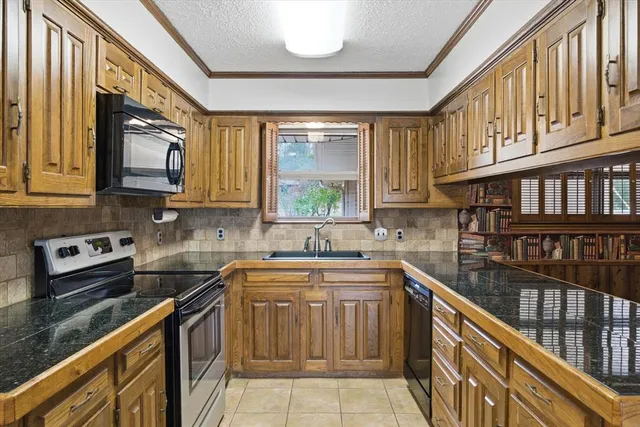 a kitchen with stainless steel appliances granite countertop a sink and cabinets