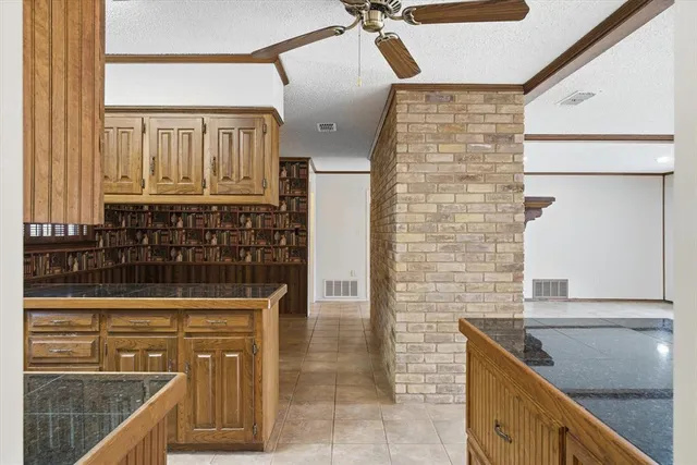 a bathroom with a granite countertop sink a mirror and shower