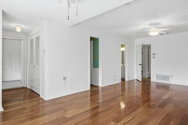 a view of an empty room with wooden floor