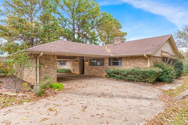 a front view of a house with a garden and yard